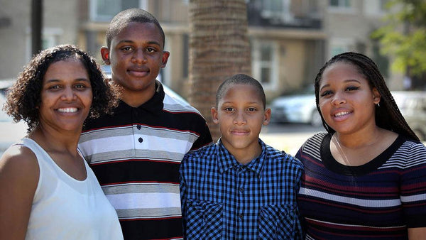 A family that is excited to have moved in to their new affordable home at Jamboree's Clark Commons.